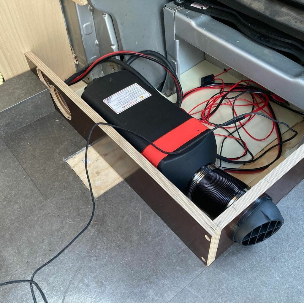 van build includes heater installed underneath cabin seat